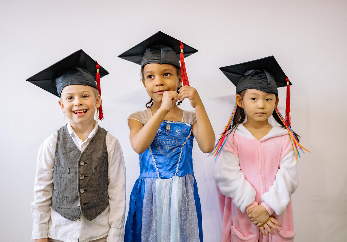 kids wearing graduation caps